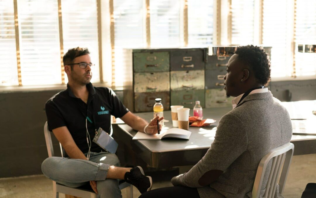 Two men talking at work