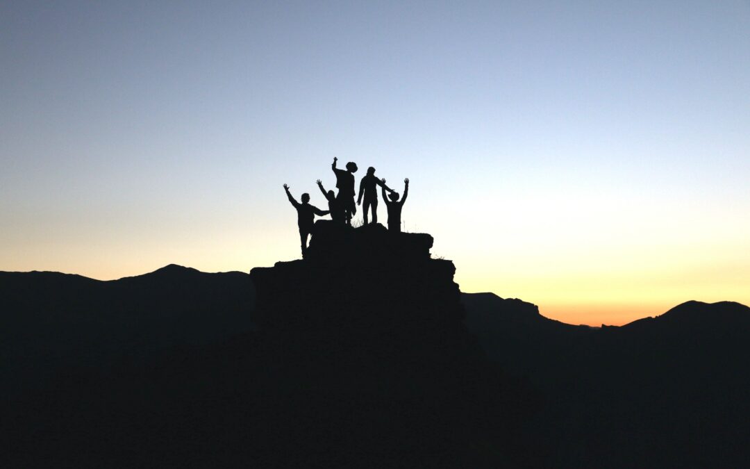 group of people on top of hill